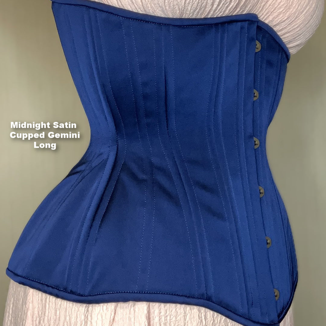 Midnight blue satin Gemini Cupped Long corset with silver busk on a neutral background, side view