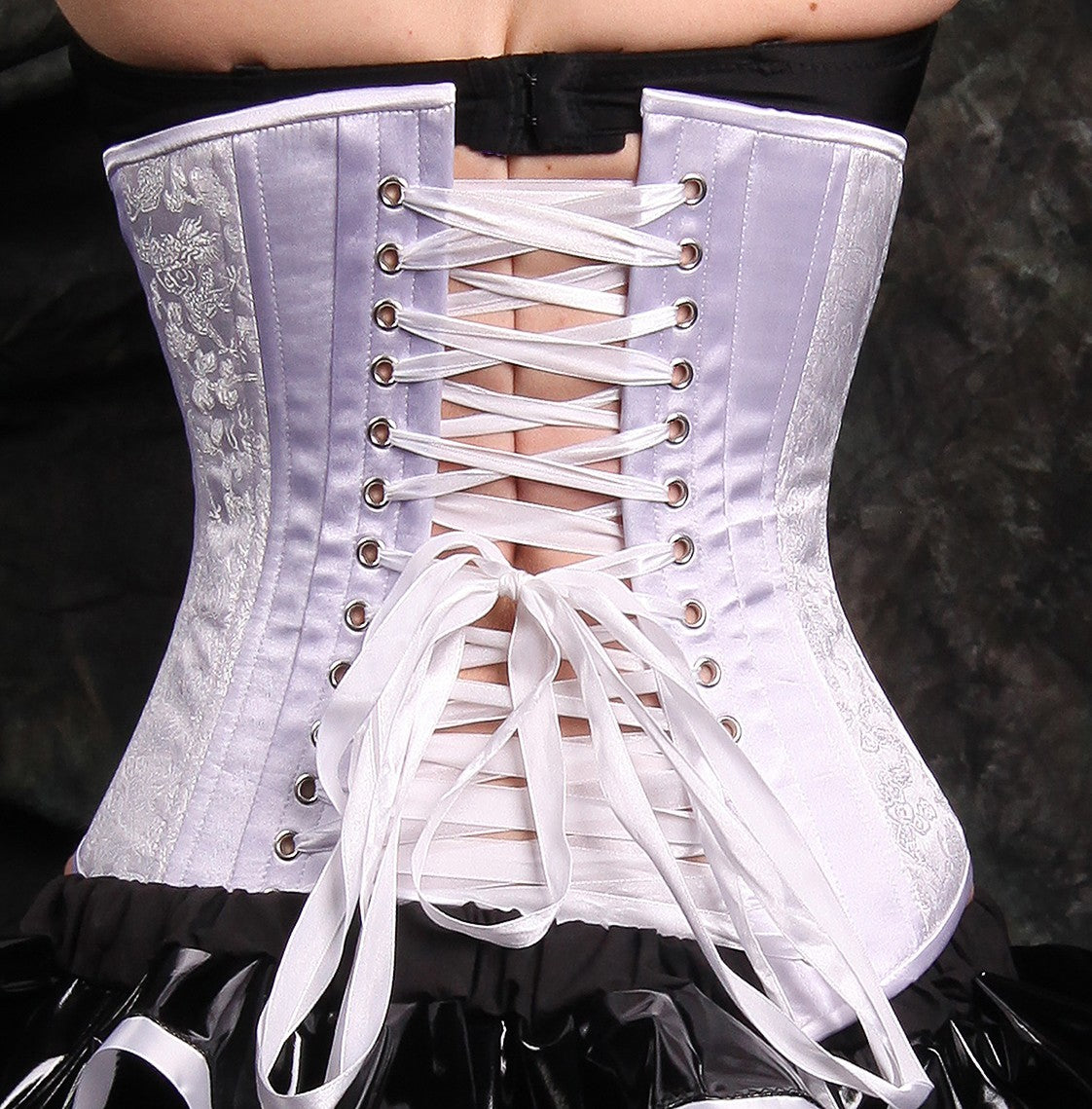 BI-21 white dragon brocade, slim silhouette, underbust corset on model with black background, back view with white ribbon laces
