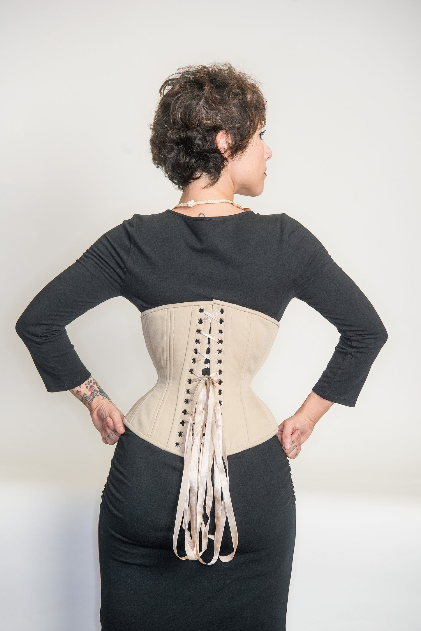 Beige cotton Libra corset, back view on model
