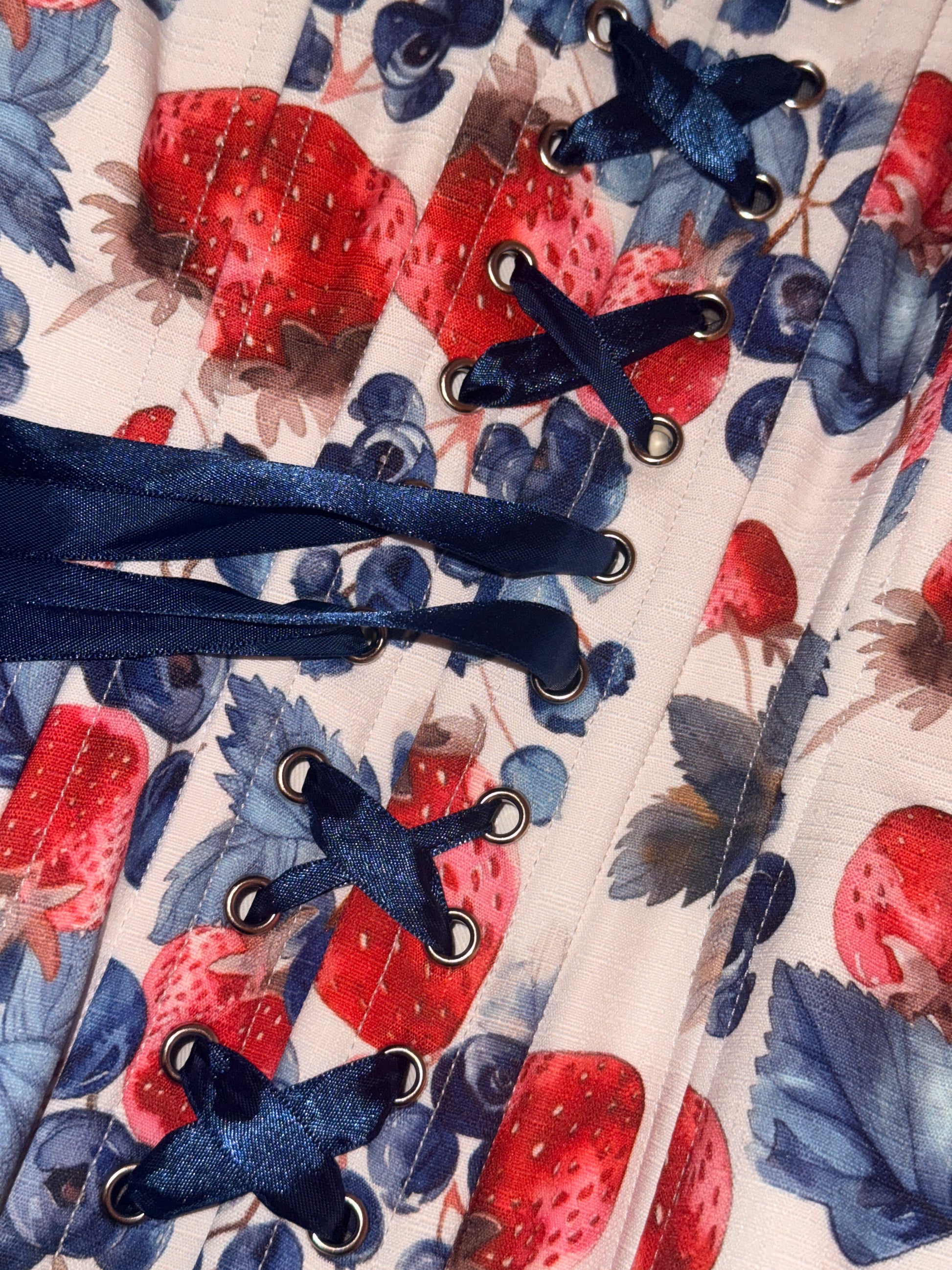 Berry Sweet Cotton corset, close up showing fabric texture details and ribbon laces