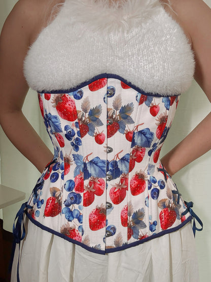 Berry Sweet Cotton corset, hourglass longline silhouette, with adjustable side hip lacing, modeled by Hannah who styled it with a fuzzy white halter top and white cotton skirt.