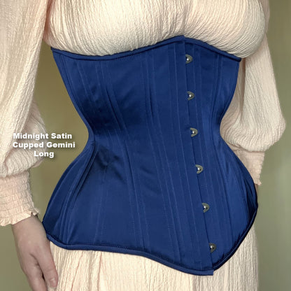 Midnight blue satin Gemini Cupped Long corset with silver busk on a neutral background, side view
