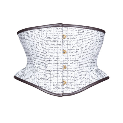 A structured corset with a white fabric body covered in black cursive script, dark brown leather binding trim along the top and bottom edges, an antique brass busk down the center front, shown on a plain white background.