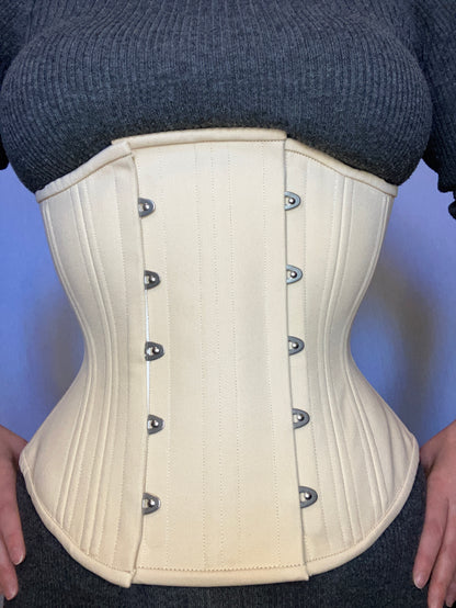 Person wearing a beige waist training corset with a 4-inch wide expander panel to make it fit better
