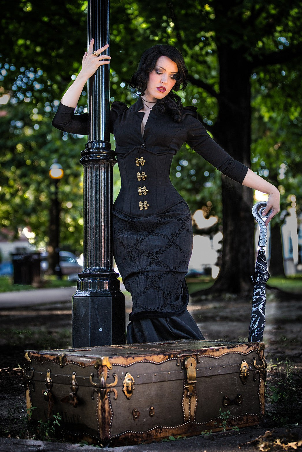 Gothic Cashmere Corset, slim silhouette, regular underbust length, front view with brass swing clasps on model out in nature
